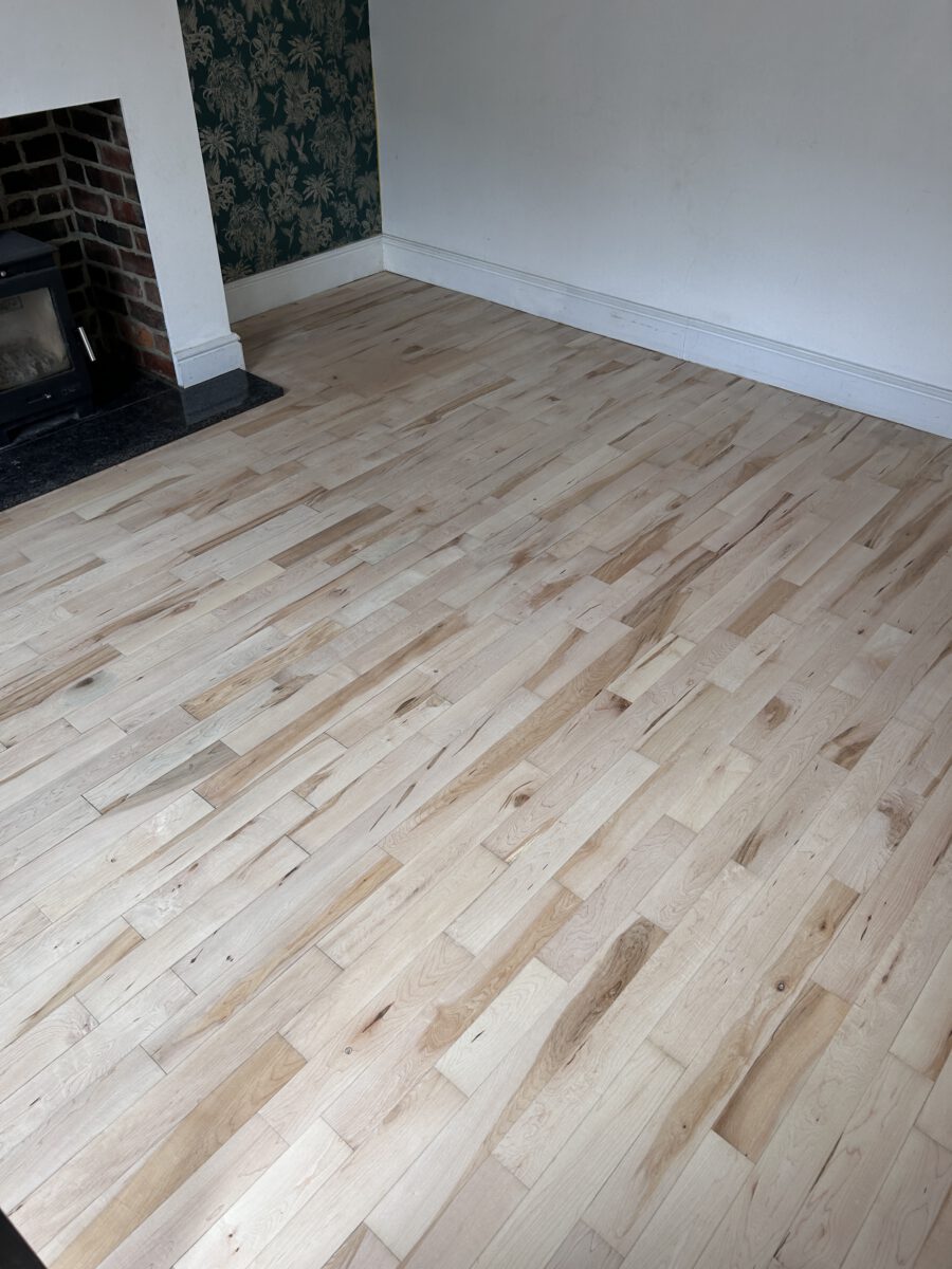 Restored maple hardwood floor after professional sanding before applying finish